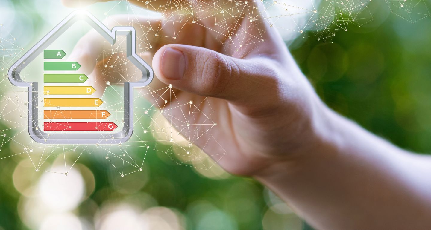 Hand zeigt eine Energie-effiziente Musterhaus